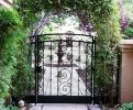 arched courtyard entry gate & panels with perforated steel backing