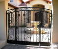 entryway with this beautiful arched gate and fixed panels  