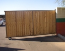 a rolling driveway gate with white cedar wood privacy slats