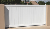 a sliding driveway gate with PVC pickets