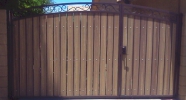 decorative arched RV gate with uneven split of gates